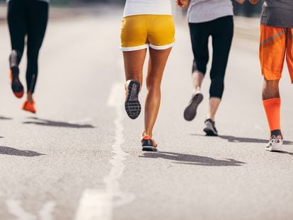 Large group of unrecognizable marathon runners having a race on the road. Copy space.