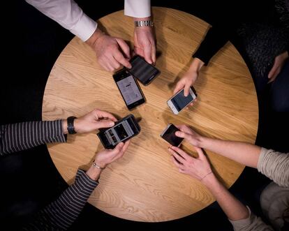 Varias personas utilizando sus teléfonos móviles