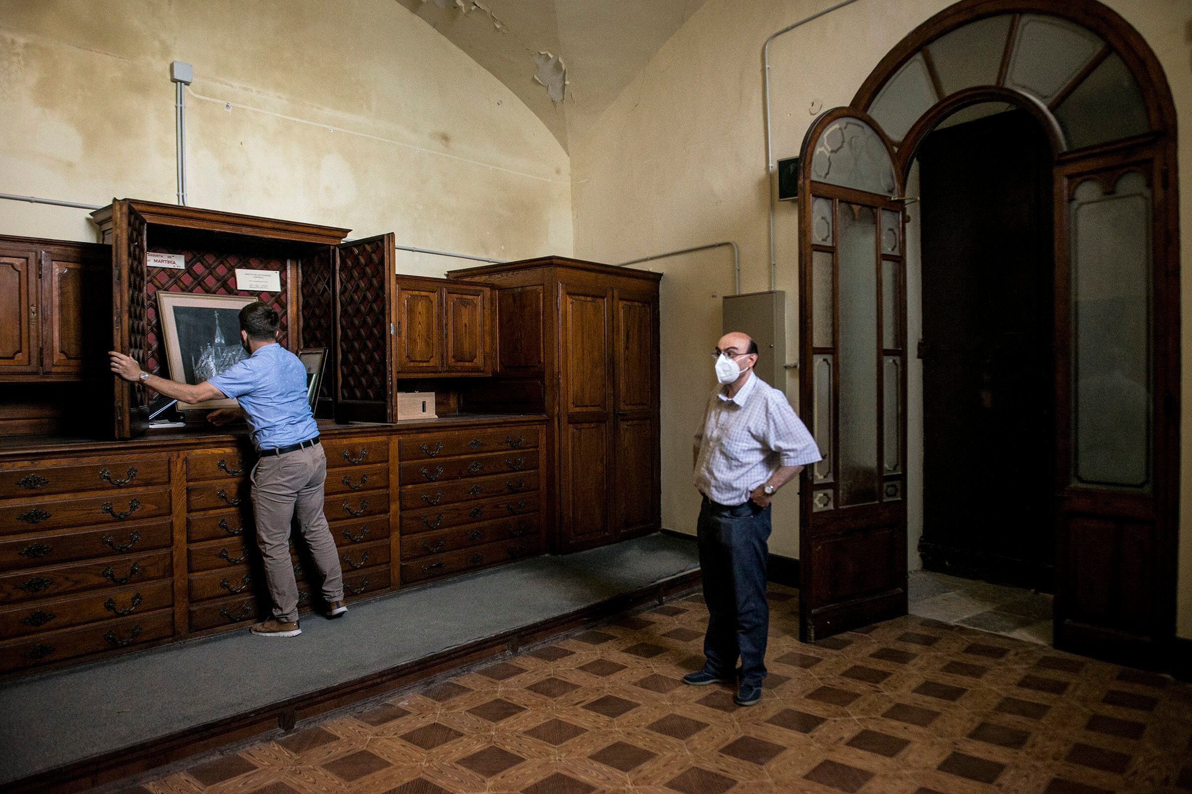 El concejal de Cultura de Banyoles, Miquel Cuenca, abre el mueble que conservaba la arqueta cuando fue robada.