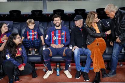 Piqué posa con su familia al final del partido en el banquillo del Camp Nou.
