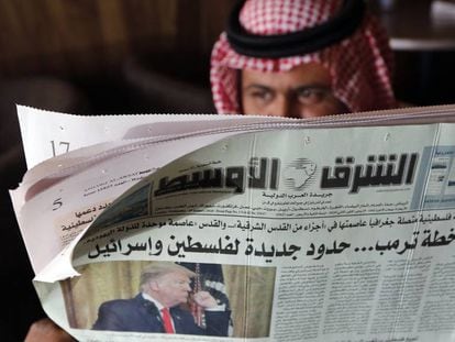 Un hombre lee en Yedda (Arabia Saudí) un periódico que lleva en portada el plan de paz de Trump.