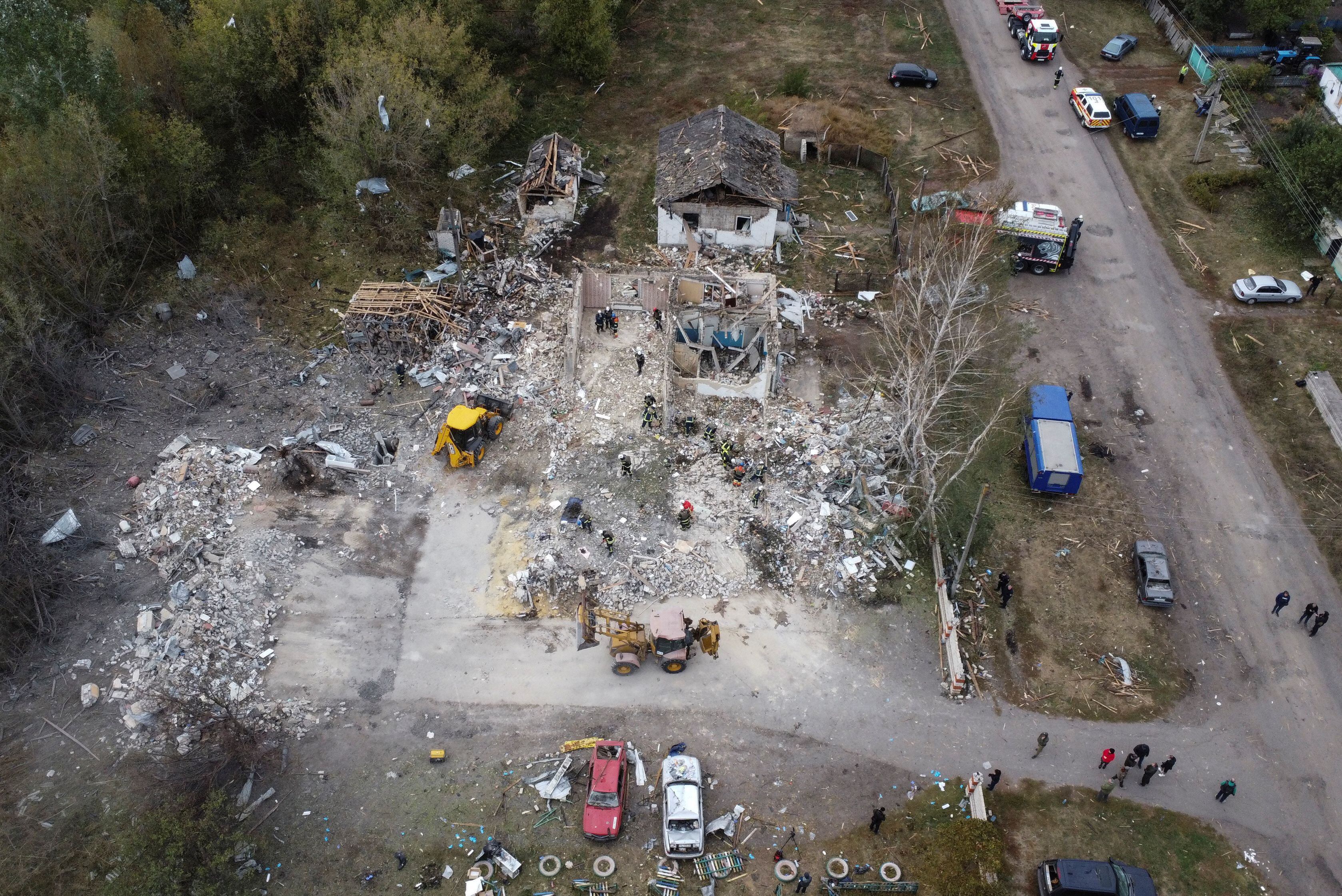 Rescues remove debris at a site of buildings of a local cafe and a grocery store, where at least 52 people were killed by a Russian missile strike, amid Russia's attack on Ukraine, in the village of Hroza, in Kharkiv region, Ukraine October 6, 2023. REUTERS/Yan Dobronosov