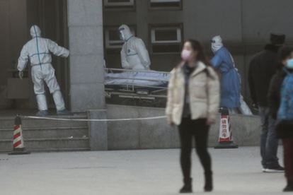 Medical staff transport a patient at Jinyintan Hospital in Wuhan in January 2020. 