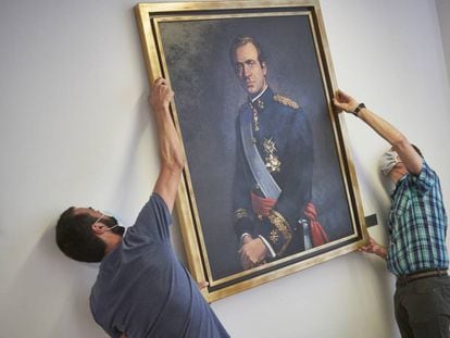 <b>Juan Carlos I, descolgado.</b> Dos operarios retiran el retrato del rey emérito Juan Carlos I de la Sala de Gobierno del Legislativo foral del Parlamento de Navarra, el pasado 15 de junio.