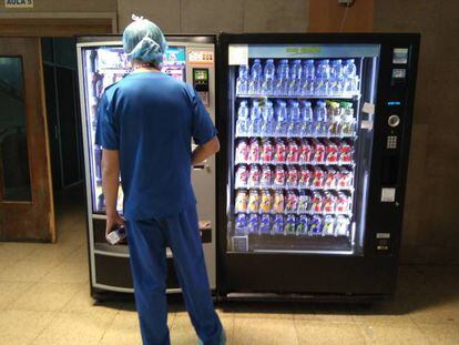 Un trabajador de un hospital frente a una máquina de 'vending'