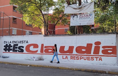Una mujer camina frente a una valla con un mensaje de apoyo a Claudia Sheinbaum, en la Ciudad de México, el 13 de junio.