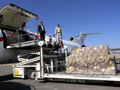 Trabajadores del aeropuerto descargan ayer el env&iacute;o de ayuda humanitaria en San&aacute;.