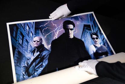 A 'Matrix' poster is displayed at an auction house in London in 1999.