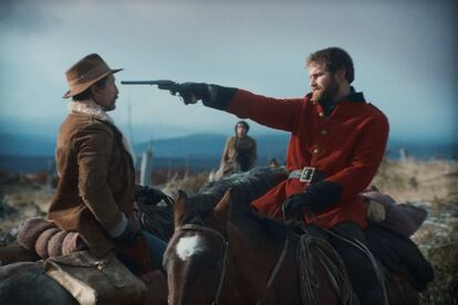 Alexander MacLennan points a gun at Colonel Martin, in a frame of the film.