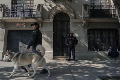 A policeman guards the house where the lifeless remains of the Tirado brothers were found. 