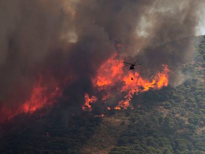 Un helicóptero cargaba agua el viernes durante las tareas de extinción del incendio en la Sierra de Mijas, en Alhaurín el Grande (Málaga).