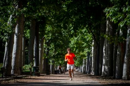 A man practices running in the Retiro Park in Madrid.
