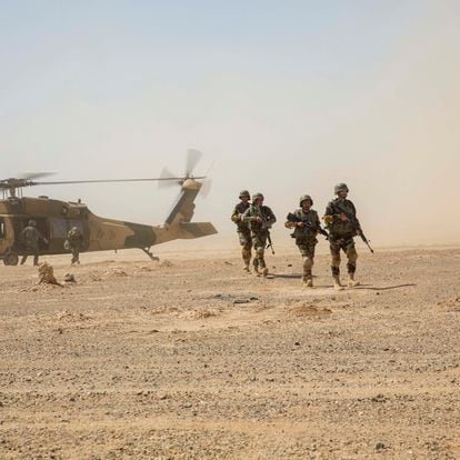 Afghan National Army 215th Corps troops disembark an Afghan Air Force (AAF) Black Hawk helicopter during a troop re-supply at Camp Shorabak in Helmand Province July 28, 2018. Picture taken July 28, 2018. To match Special Report USA-AFGHANISTAN/PILOTS.  U.S. Marine Corps/1st Lt. Kathleen Kochert/Handout via REUTERS THIS IMAGE HAS BEEN SUPPLIED BY A THIRD PARTY.