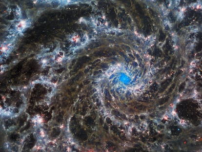 This image from the NASA/ESA/CSA James Webb Space Telescope shows the heart of M74, otherwise known as the Phantom Galaxy. Webb’s sharp vision has revealed delicate filaments of gas and dust in the grandiose spiral arms which wind outwards from the centre of this image. A lack of gas in the nuclear region also provides an unobscured view of the nuclear star cluster at the galaxy's centre. M74 is a particular class of spiral galaxy known as a ‘grand design spiral’, meaning that its spiral arms are prominent and well-defined, unlike the patchy and ragged structure seen in some spiral galaxies. The Phantom Galaxy is around 32 million light-years away from Earth in the constellation Pisces, and lies almost face-on to Earth. This, coupled with its well-defined spiral arms, makes it a favourite target for astronomers studying the origin and structure of galactic spirals. Webb gazed into M74 with its Mid-InfraRed Instrument (MIRI) in order to learn more about the earliest phases of star formation in the local Universe. These observations are part of a larger effort to chart 19 nearby star-forming galaxies in the infrared by the international PHANGS collaboration. Those galaxies have already been observed using the NASA/ESA Hubble Space Telescope and ground-based observatories. The addition of crystal-clear Webb observations at longer wavelengths will allow astronomers to pinpoint star-forming regions in the galaxies, accurately measure the masses and ages of star clusters, and gain insights into the nature of the small grains of dust drifting in interstellar space. Hubble observations of M74 have revealed particularly bright areas of star formation known as HII regions. Hubble’s sharp vision at ultraviolet and visible wavelengths complements Webb’s unparalleled sensitivity at infrared wavelengths, as do observations from ground-based radio telescopes such as the Atacama Large Millimeter/submillimeter Array, ALMA. Scientists must combine data from telescopes oper