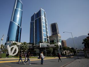 A group of people crossing a street in the city of San Pedro Garza García, in the Mexican state of Monterrey.