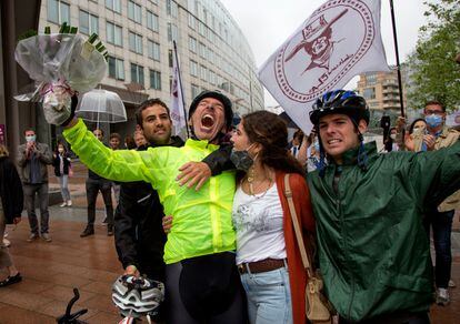 Jaime Lafita (de amarillo) emocionado junto a sus tres hijos tras llegar en bicicleta a la sede del Parlamento Europeo de Bruselas.