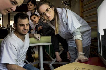 Iria Somoza y Marta Grela, estudiantes de podología, junto al cirujano podólogo Eduardo Simón, valoran las radiografías de Hicham, que padece una malformación congénita y es uno de los casos susceptibles de ser operados.