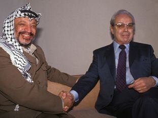 Yasser Arafat, primer presidente de la Autoridad Nacional Palestina y Javier Pérez de Cuellar, se saludan durante una reunión en Ginebra en 1990.