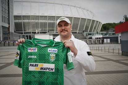 Igor Palamarchuk, a fan of Dinamo kyiv, with a shirt signed by the players of Karpaty Lviv in front of the Olympic stadium in kyiv.