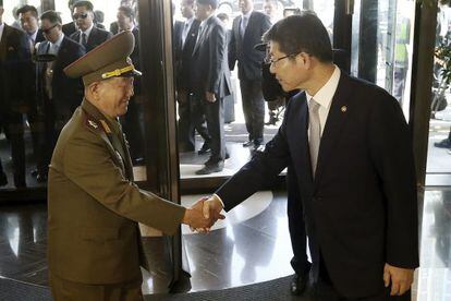 Un alto cargo norcoreano saluda al ministro de Unificaci&oacute; surcoreano este s&aacute;bado.