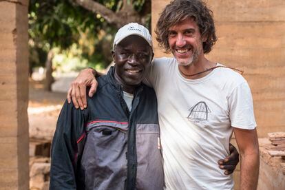 David García, one of the project's architects, poses with Kaoussou Niassy, ​​'Eno', master bricklayer.