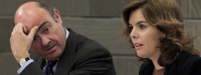 La vicepresidenta, Soraya Sáenz de Santamaría, y el ministro de Economía, Luis de Guindos, tras el Consejo de Ministros de este viernes.