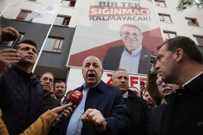 The ultranationalist politician Ümit Özdag speaks to the media under a banner that reads: 