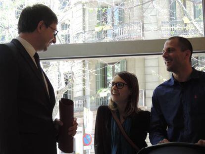 El consejero de Justicia, Carles Mundó, charla con la primera pareja inscrita en el registro.