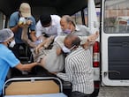 Healthcare workers and relatives carry Shashikantbhai Parekh, a patient with breathing problem, out from an ambulance for treatment at a COVID-19 hospital, amidst the spread of the coronavirus disease (COVID-19) in Ahmedabad, India, April 28, 2021. REUTERS/Amit Dave
