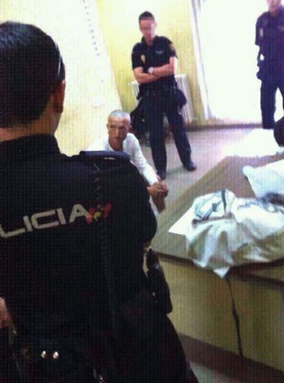 Tres agentes vigilan a Manuel Fernández Rodríguez tras su detención.