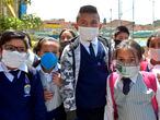 Colombian students pose for a picture wearing face masks made of recyclable and biodegradable materials, as a form of protest against the shortage of face masks in pharmacies, in order to prevent the spread of the COVID-19 virus, at Julio Cesar Turbay school, in Soacha, Colombia, on March 11, 2020. - The World Health Organisation (WHO) declared the Coronavirus a pandemic with 118,000 cases in about 120 countries, and 4000 deaths. (Photo by Raul ARBOLEDA / AFP)