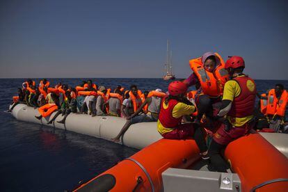 Una zodiac de Proactiva Open Arms se aproxima a un bote atestado de migrantes nigerianos, a 17 kilómetros de la costa libia. La ONG rescató a más de 700 el domingo.