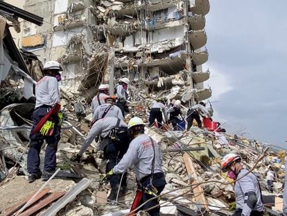 This photo provided by Miami-Dade Fire Rescue, search and rescue personnel search for survivors through the rubble at the Champlain Towers South Condo in Surfside, Fla., section of Miami,  Friday, June 25, 2021. The apartment building partially collapsed on Thursday. (Miami-Dade Fire Rescue via AP)