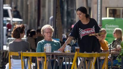 Una camarera atiende una mesa en el barrio del Born (Barcelona).