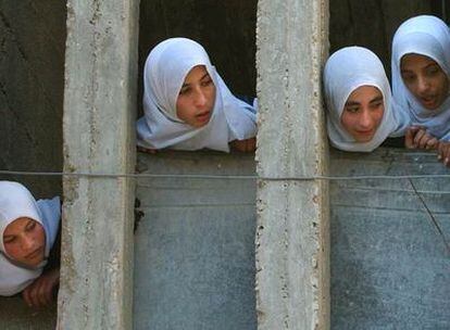 Cuatro jóvenes palestinas observan la llegada de los <i>escudos humanos</i> a la casa de Wael Rajab.