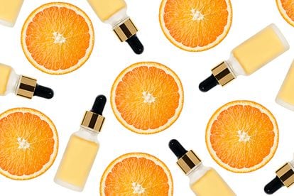 Beauty pattern made of Vitamin C serum in cosmetic bottle with dropper and slices of orange