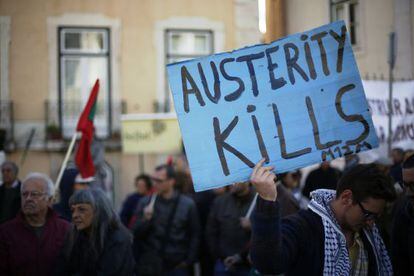 Un manifestante sostiene un cartel en que se lee "La austeridad mata", en una protesta frente al Parlamento portugués en Lisboa.