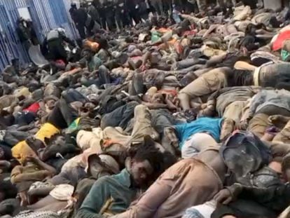 SENSITIVE MATERIAL. THIS IMAGE MAY OFFEND OR DISTURB    A view shows a large number of African migrants lying closely piled together, with Moroccan security forces standing over them in riot gear, at the Barrio Chino Border Checkpoint, Morocco, in this undated screen grab taken from a social media video obtained by Reuters on June 25, 2022. AMDH/via REUTERS  THIS IMAGE HAS BEEN SUPPLIED BY A THIRD PARTY. MANDATORY CREDIT. NO RESALES. NO ARCHIVES.