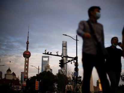 People wearing face masks walk through Shanghai on September 21.