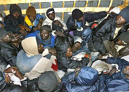 Un grupo de inmigrantes en el interior de la patera en la que fueron interceptados por la Guardia Civil a su llegada a Fuerteventura el pasado enero.