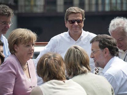 Merkel dialoga con Rajoy, junto a García-Margallo y Jorge Moragas, a bordo de un barco en Chicago. / FOTO: GUIDO BERGMANN (EFE)