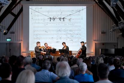 El Cuarteto van Kuijk interpreta el 'Cuarteto op. 135' de Beethoven. Detrás de ellos, una reproducción digital de la primera página del manuscrito.