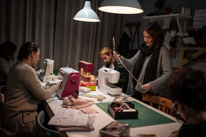 The teacher Begoña Plaza, standing, gives some guidelines to the students of the sewing class at La Laborteca, a studio in Madrid. 