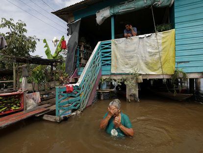 Iracema Guimaraes da Costa, una campesina de la comunidad de Careriro de Vareza, en el Estado de Amazonia, frente a su casa inundada por el aumento en el nivel de un río aledaño, el 20 de mayo de 2022.