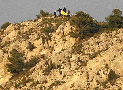 Miembros del equipo de rescate, junto al cadáver de María Dolores Yeste, en la sierra de Maigmó.