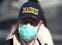 A man, wearing a protective mask, walks through an empty street due to the coronavirus outbreak in central Madrid, Spain, March 14, 2020. REUTERS/Sergio Perez