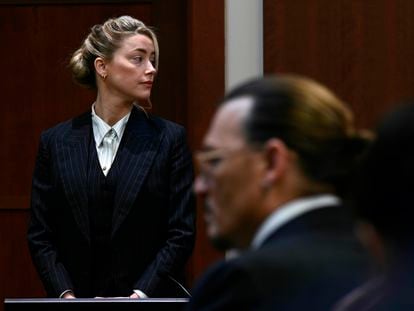 Actors Amber Heard and Johnny Depp, watch the jury arrive in the courtroom at the Fairfax County Circuit Courthouse in Fairfax, Va., Tuesday, May 17, 2022. Depp sued his ex-wife Amber Heard for libel in Fairfax County Circuit Court after she wrote an op-ed piece in The Washington Post in 2018 referring to herself as a "public figure representing domestic abuse." (Brendan Smialowski/Pool photo via AP)