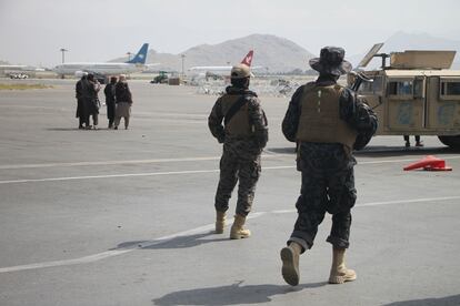 Taliban militiamen at Kabul airport last August.