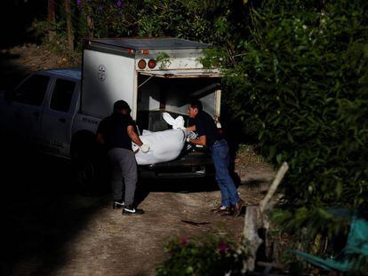 Dos agentes recogen el cuerpo de un asesinado en San Salvador. 