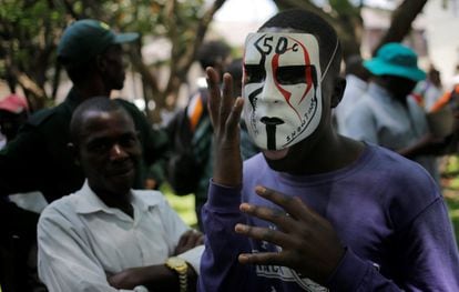 El partido en el gobierno, la Unión Nacional Africana de Zimbabue-Frente Patriótico (ZANU-PF) ha impulsado una moción de censura contra Mugabe en el Parlamento. En la imagen, un manifestante con una máscara durante las protestas frente al Parlamento en Harare (Zimbabue) el 21 de noviembre.